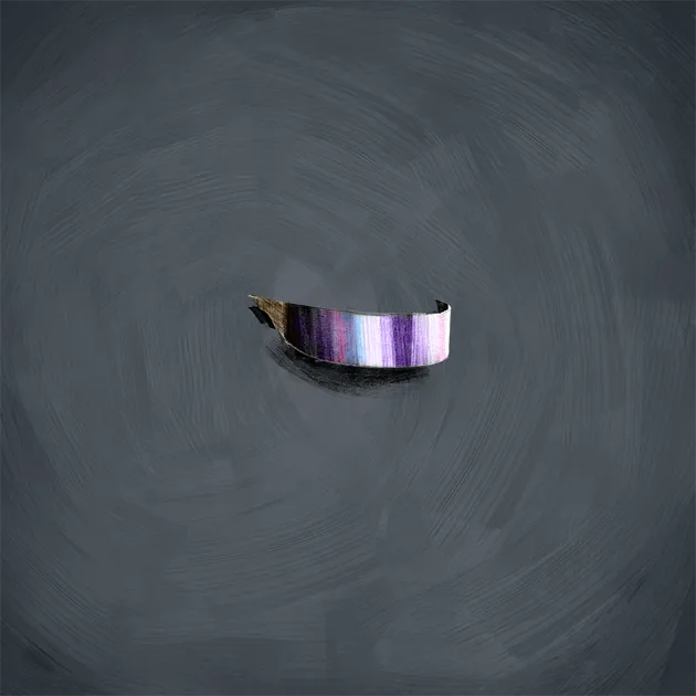 A floating VR visor on a painted slate ground